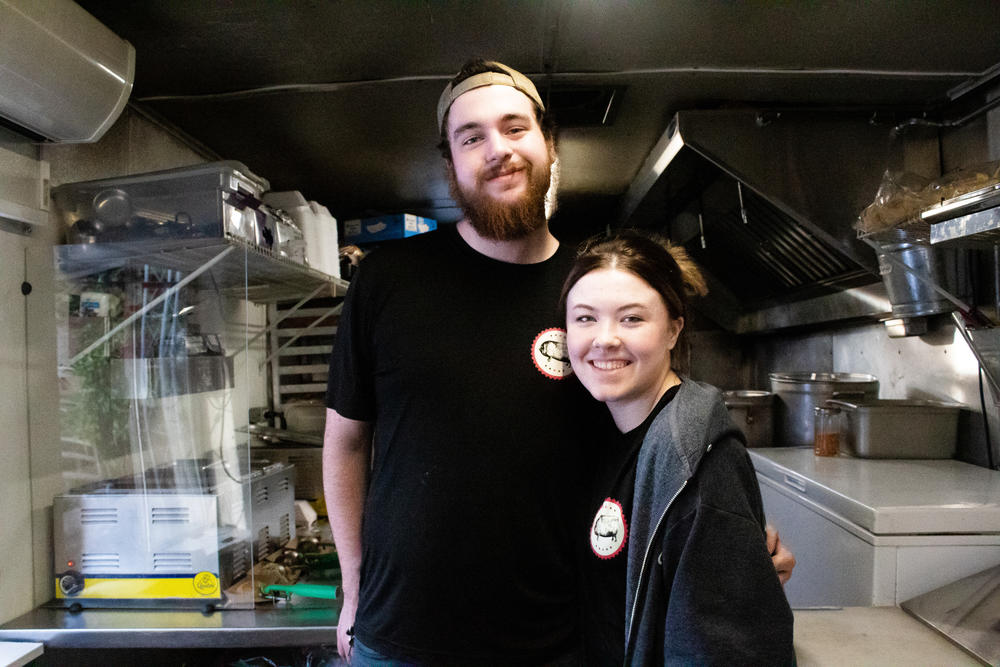 Levi Brock and Megan Eaves of Choate BBQ smile inside their food truck while serving in Woodstock, Georgia on Feb. 16. 