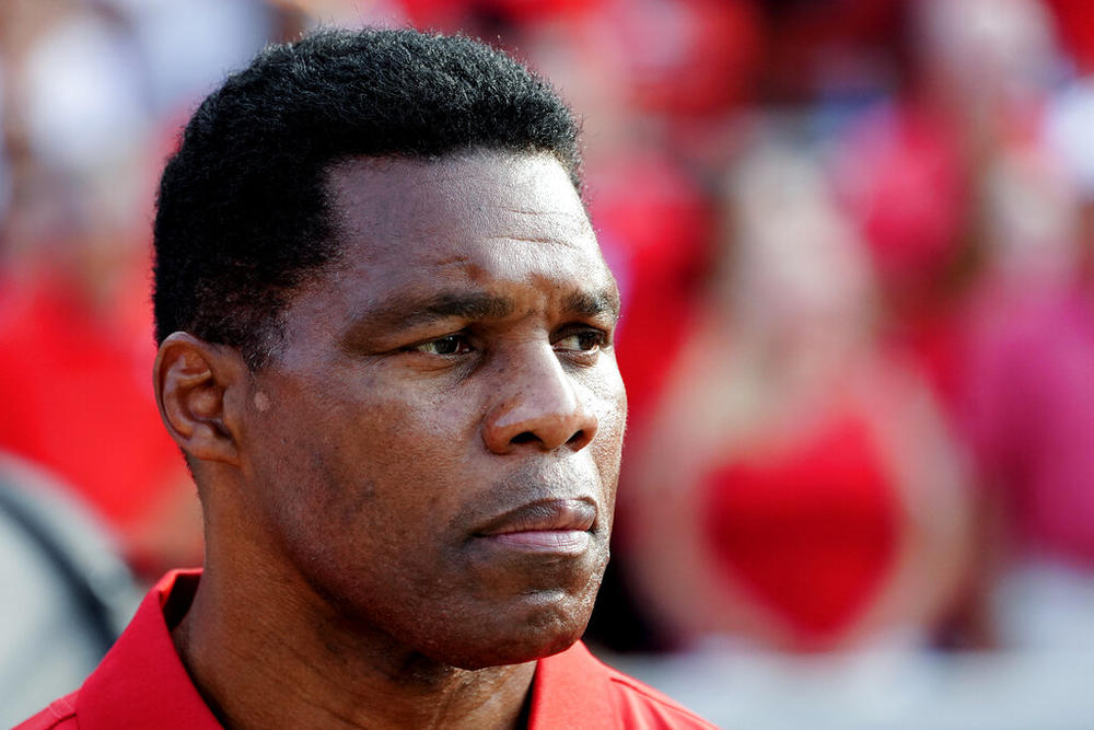 Former Georgia running back and Republican Georgia Senate candidate Herschel Walker attends a college football game between UAB and Georgia, Sept. 11, 2021, in Athens, Ga. Police in Irving, Texas once confiscated a gun from Walker following a domestic disturbance because the former football legend talked about having “a shoot-out with police.” The revelation was included in a 2001 police report that recently obtained by The Associated Press.