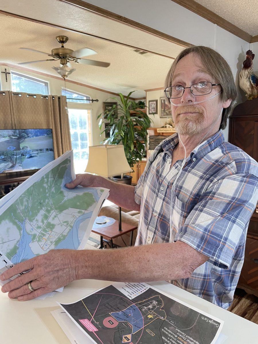 Ricky Manning looks over maps of the Union Carbide site, where he once worked. 