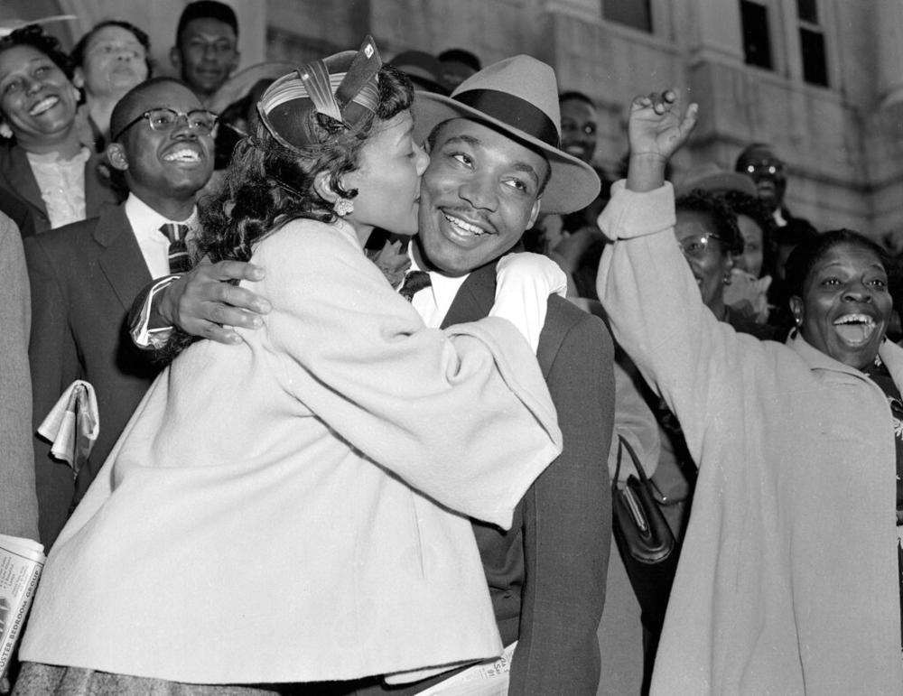 The Rev. Martin Luther King Jr. is welcomed with a kiss by his wife Coretta Scott King after leaving court in Montgomery, Ala., in a file photo from March 22, 1956. The two were married at a now-vacant house near Marion, Ala., three years earlier.