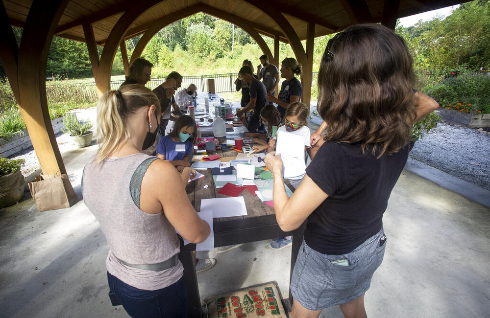 People make paper log books to measure and document local river flow rates at a workshop led by Jonathon Keats, an American conceptual artist, on Saturday, Sept. 18, 2021, in Atlanta. Keats is in the process of devising a municipal clock to be located in Atlanta which would display time based on the flow rate of local rivers and waterways. Keats envisions the project as a way for people to have a closer connection with their natural surroundings.