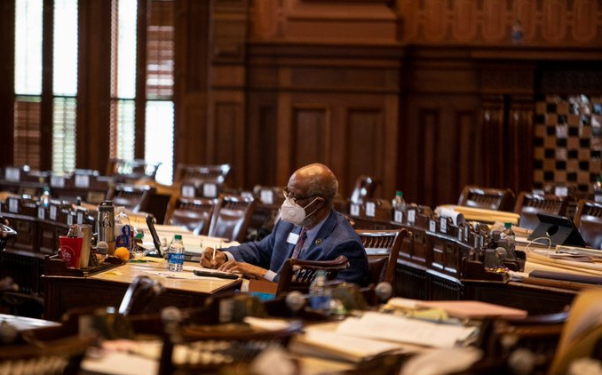 Rep. Calvin Smyre, D-Columbus, sits by himself on the House floor during lunch, preparing his speech for the hate crimes bill signing. Smyre co-sponsored the original legislation.