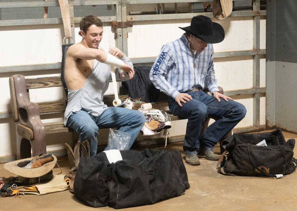 Bareback riders Isaac Ingram (left) and Hunter Ramsey (right) preparing for their part of the competition in the backstage area.