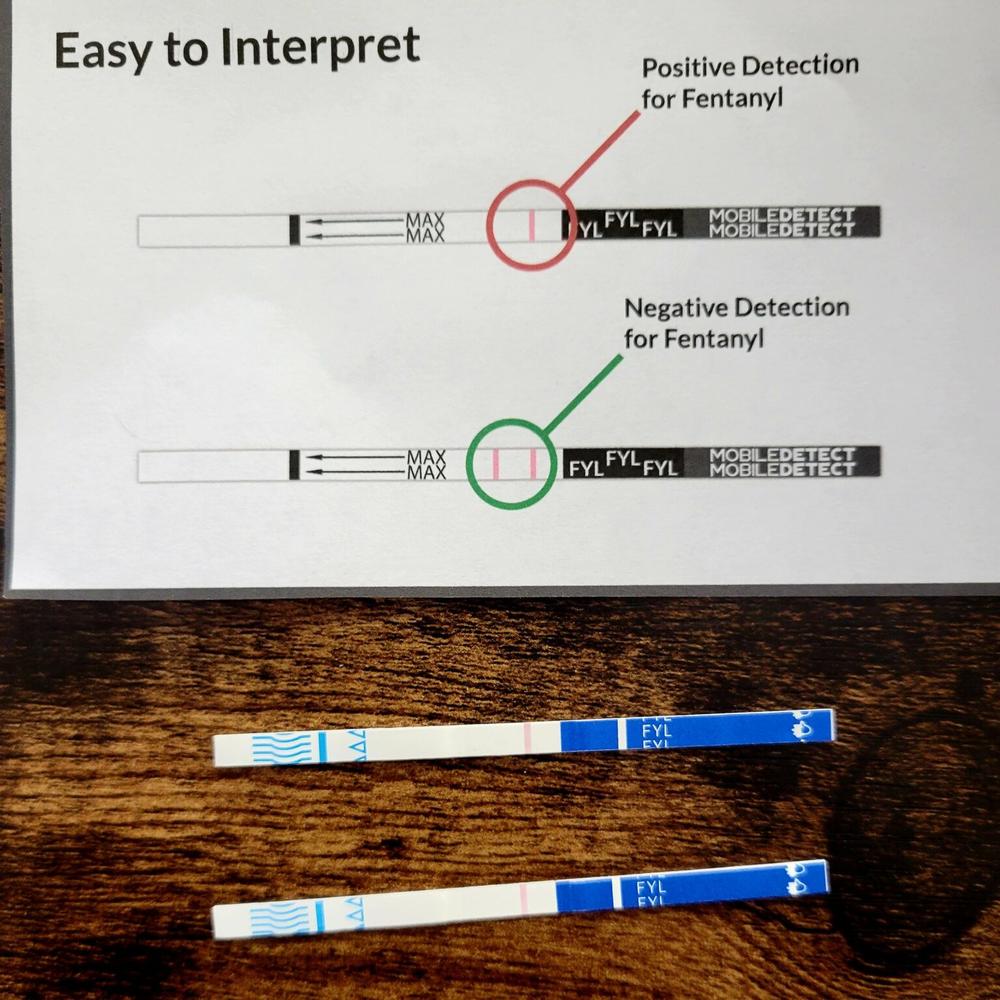  Two fentanyl test strips showing positive results. 