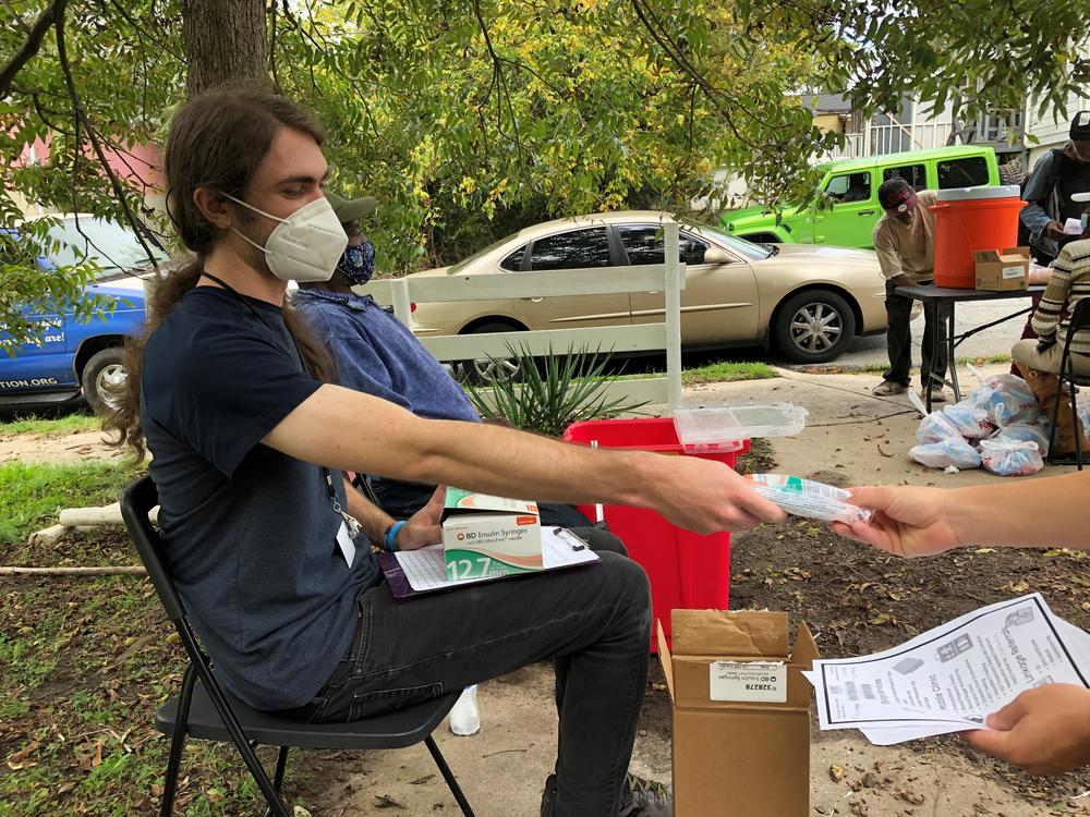 A volunteer with the Atlanta Harm Reduction Coalition gives out sterile syringes in exchange to get potentially contaminated needles off the street.