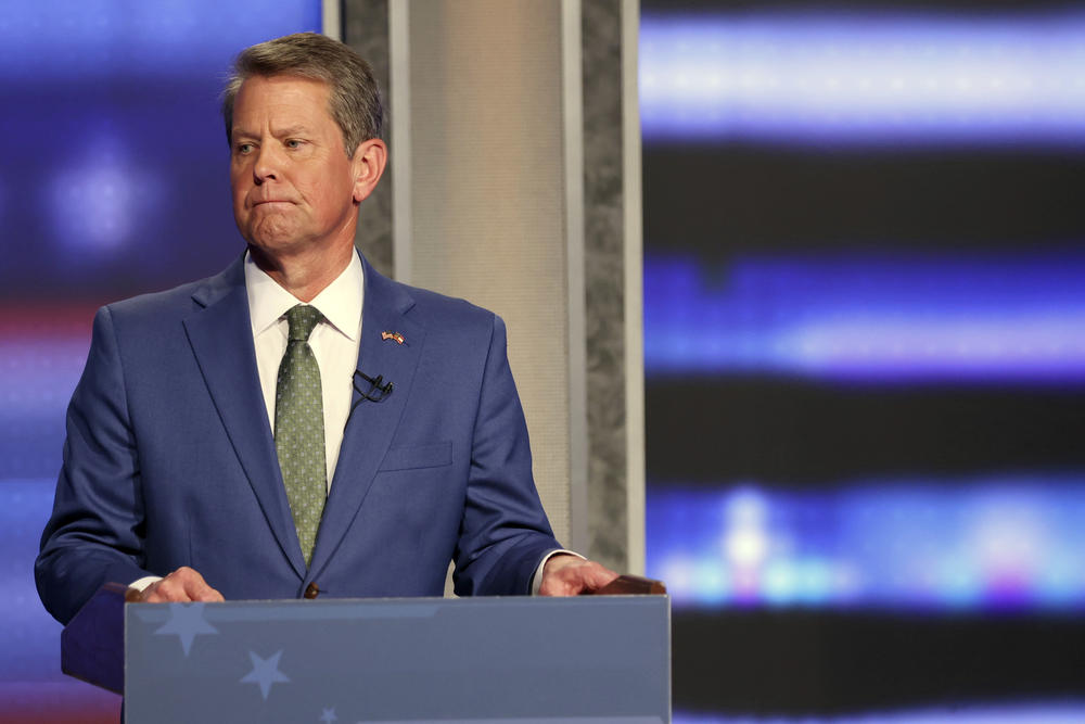 Georgia Gov. Brian Kemp reacts as he tries to ignore an answer from former Sen. David Perdue during a Republican gubernatorial debate, Sunday, April 24, 2022, in Atlanta.