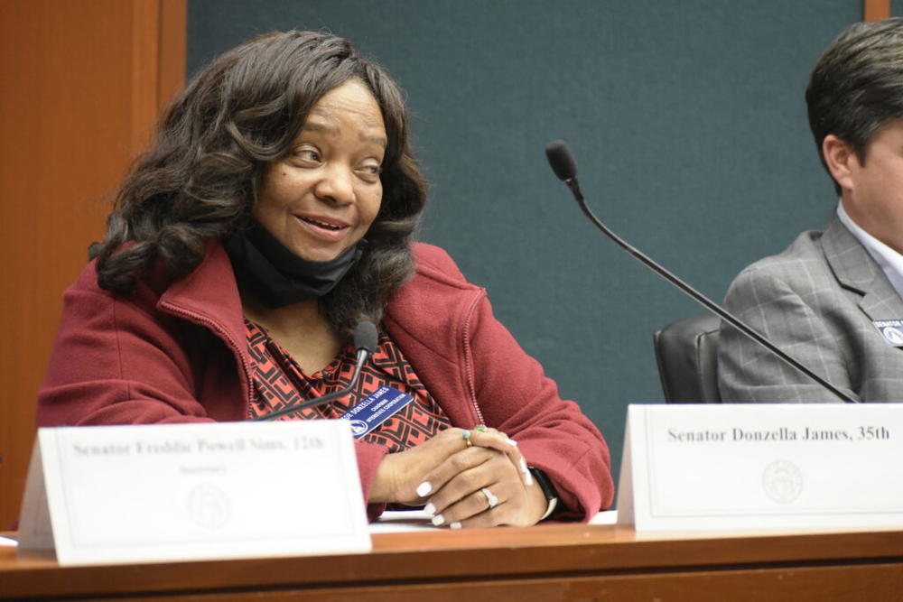 Atlanta Democratic state Sen. Donzella James is one of more than 110,000 Georgians hospitalized with COVID-19 since the pandemic claimed Georgia’s first reported death. She lowered her mask to speak during a senate committee hearing. 
