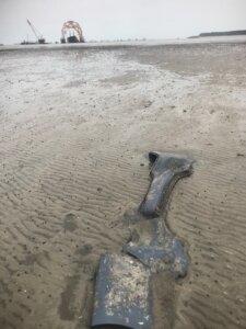  Car debris from the shipwrecked Golden Ray washed upon a St. Simons mud flat. 