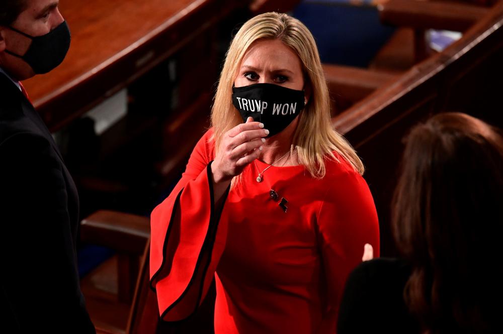 In this Sunday, Jan. 3, 2021, file photo, Rep. Marjorie Taylor Greene, R-Ga., wears a "Trump Won" face mask as she arrives on the floor of the House to take her oath of office on opening day of the 117th Congress at the U.S. Capitol in Washington. 
