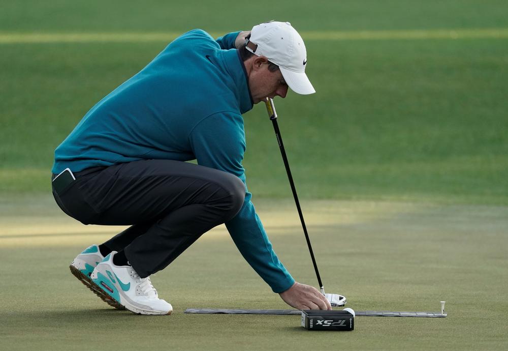 Rory McIlroy lines up a putt.