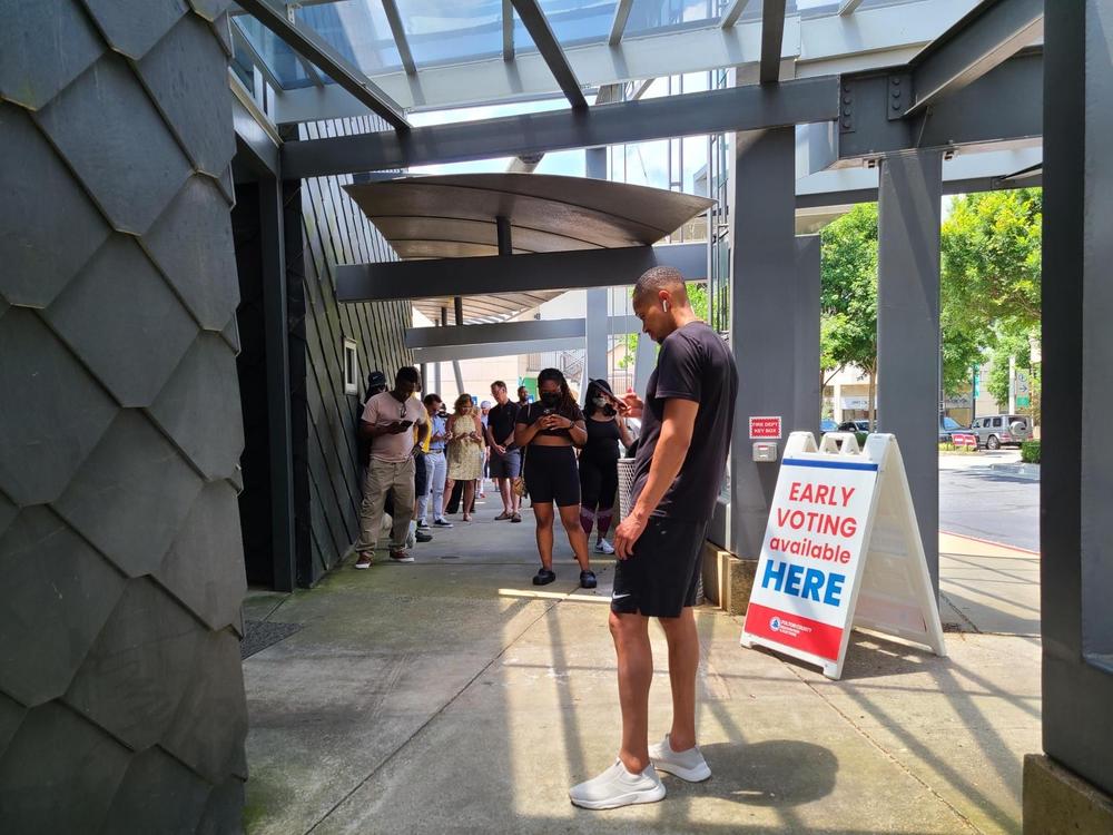 Atlanta voters line up to cast ballots outside an early voting polling place in Buckhead on Friday, May 20, 2022. The early voting period ahead of the May 24 primary saw record turnout in Georgia.