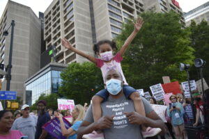 Demonstrators gather at Centennial Olympic Park before marching to the Capitol.