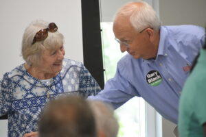 Gary Black speaks with a supporter at a campaign event in Smyrna.
