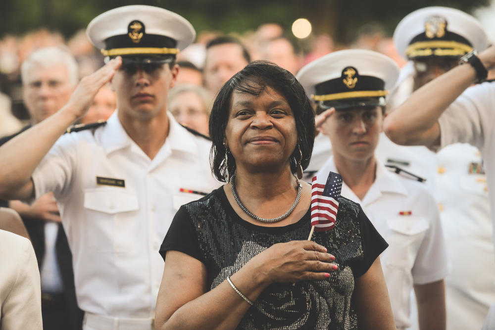 An audience member stands for the national anthem at a previous broadcast of the National Memorial Day Concert.