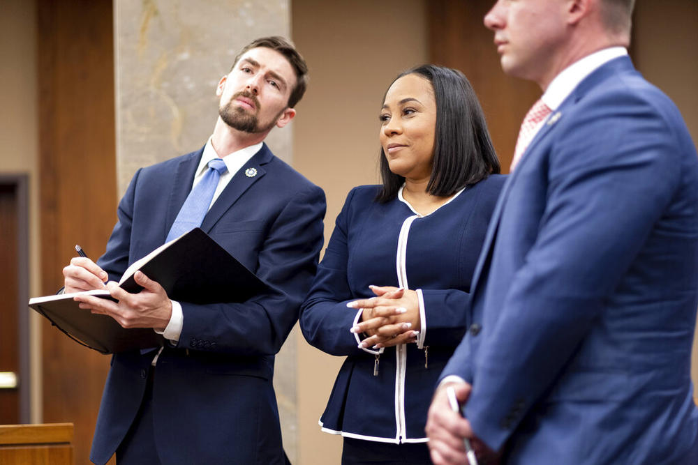 Fulton County District Attorney Fani Willis, center, and members of her team watch as potential jurors are excused during proceedings to seat a special purpose grand jury in Fulton County, Georgia, on Monday, May 2, 2022, to look into the actions of former President Donald Trump and his supporters who tried to overturn the results of the 2020 election. The hearing took place in Atlanta. 