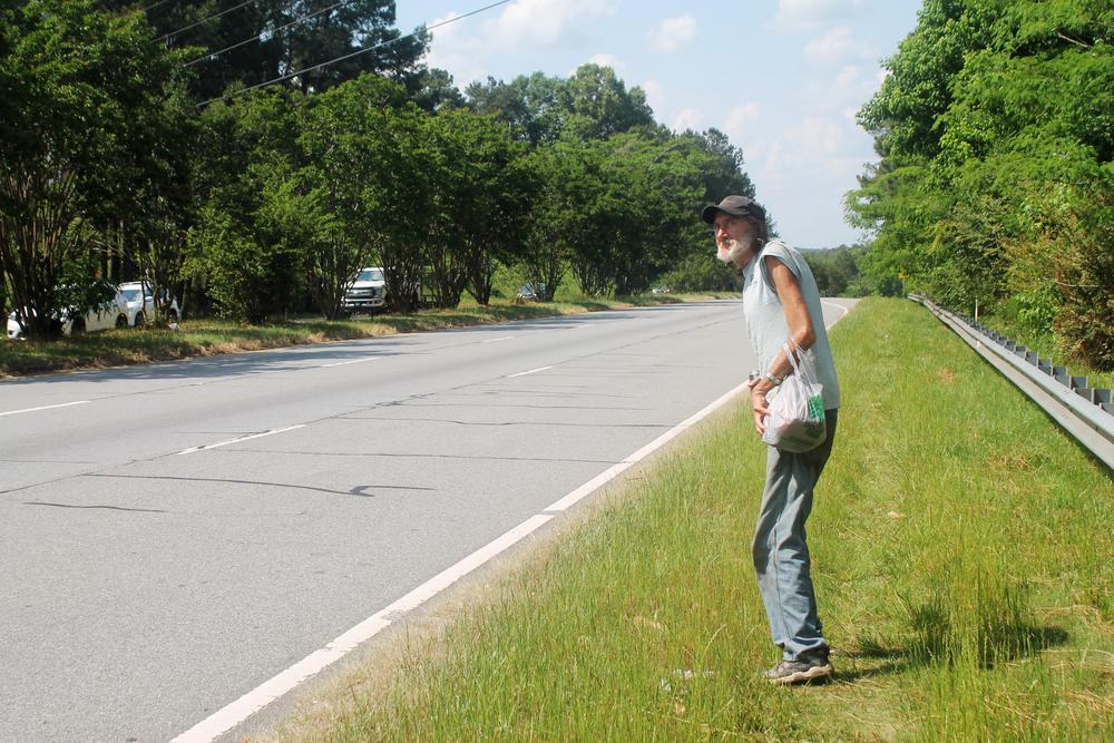 Thomas Bemke, 60, carries his shopping as he prepares to cross six lanes of Gray Highway in Macon recently. 