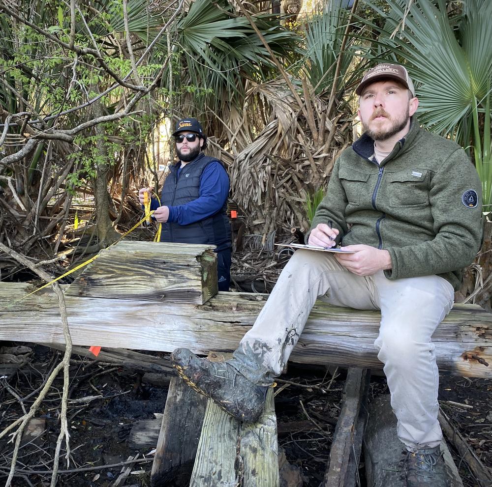 Maritime history students at Georgia Southern University measure old boat rails at Young's Marina.