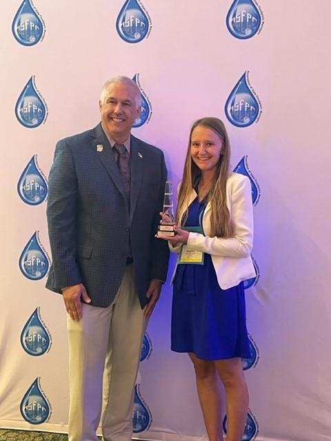 Meaghan Angelina accepts an award from the Society of Floodplain Managers.