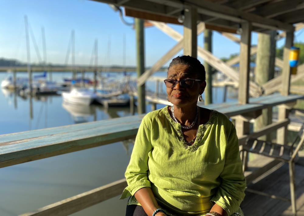 Sarah Suggs, owner of Young's Marina on Wilmington Island, sits on the porch of her dock house.