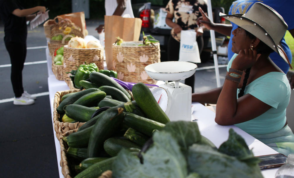 Farmer sells vegetables at the WIC market in Macon.