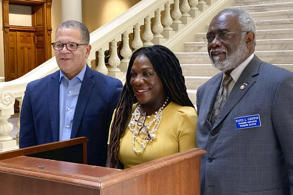 Former state Rep. Dee Dawkins-Haigler, center, a Democratic candidate for Georgia secretary of state, poses for a photo with former Fulton County Board of Commissioners Chairman John Eaves, left, and former Milledgeville mayor and state Sen. Floyd Griffin on Wednesday, June 1, 2022, at the state Capitol in Atlanta. The two men were also Democratic candidates for secretary of state and have endorsed Dawkins-Haigler in a June 21 runoff election.