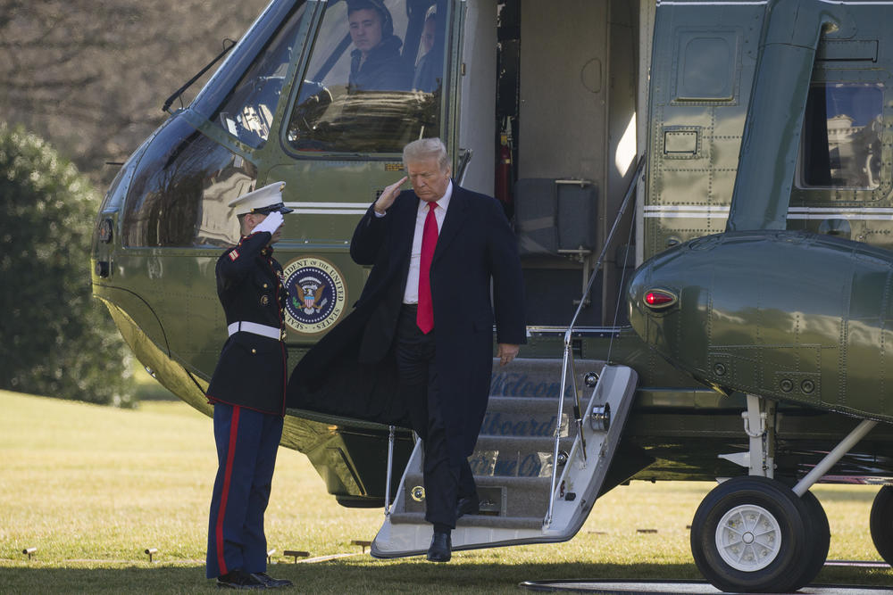 President Donald Trump salutes as he steps off Marine One on the South Lawn of the White House,