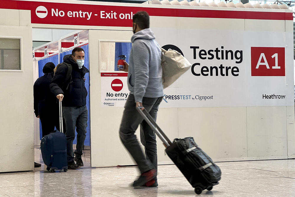 Passengers get a COVID-19 test at Heathrow Airport in London, Nov. 29, 2021. The Biden administration is lifting its requirement that international air travelers to the U.S. take a COVID-19 test within a day before boarding their flights, easing one of the last remaining government mandates meant to contain the spread of the coronavirus. A senior administration official says the mandate expires Sunday at 12:01 a.m. Eastern time.