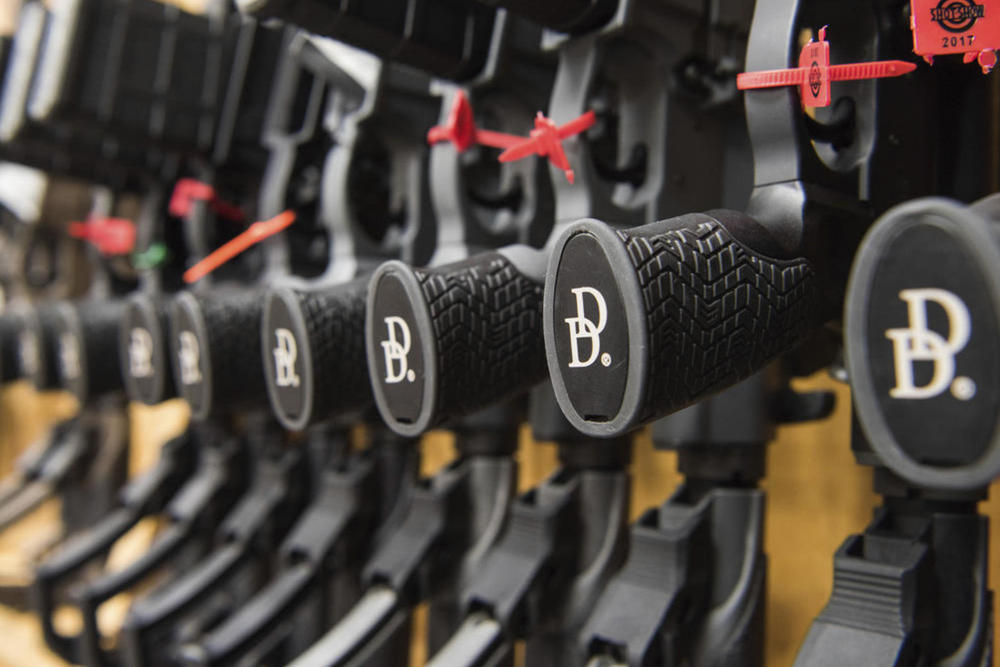 A row of AR-15 style rifles manufactured by Daniel Defense sit in a vault at the company's headquarters in Black Creek, Ga. In July 2022, the company's CEO was called to testify before a congressional committee investigating the gun industry. Credit: AP Photo/Lisa Marie Pane