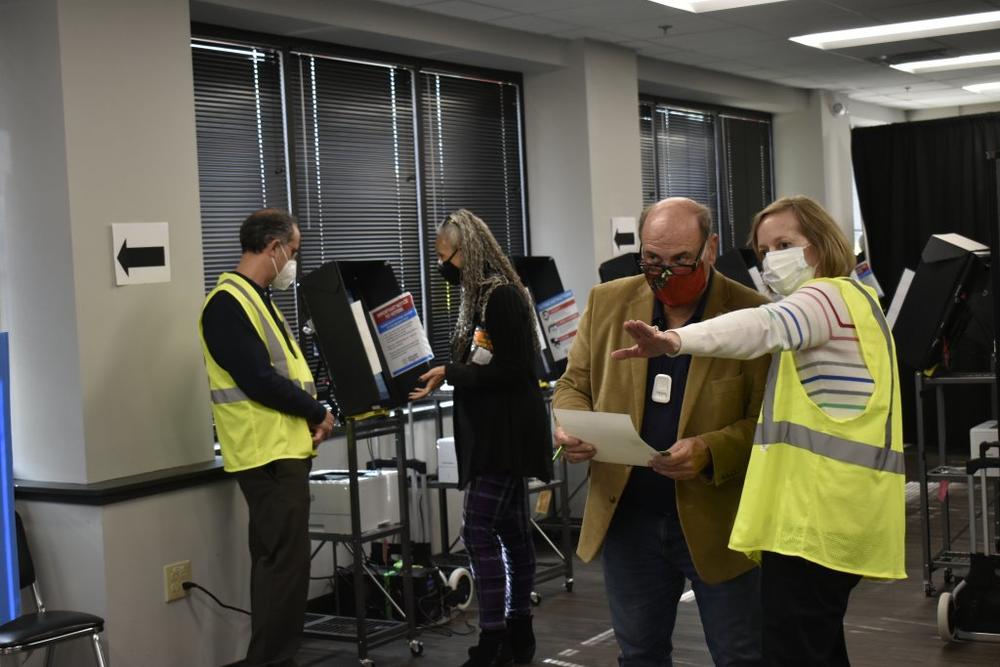 In Georgia, the Legislature gave the Georgia Bureau of Investigation authority to investigate election crimes and issue relevant subpoenas. Cobb County poll workers helped voters cast ballots in 2020.