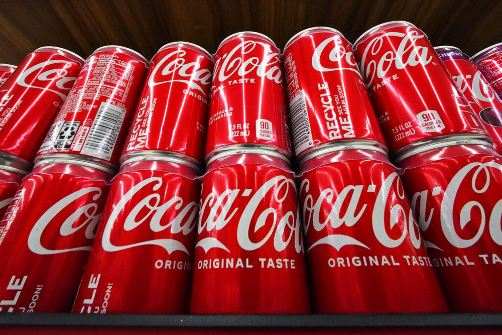 Cans of Coca-Cola are on display at a grocery market in Uniontown, Pa, on Sunday, April 24, 2022. Coca-Cola posted higher-than-expected sales in the second quarter, Tuesday, July 26, due to price increases and continuing improvement in demand at restaurants and other venues. The Atlanta-based company said revenue grew 12% in the April-June period to $11.3 billion.