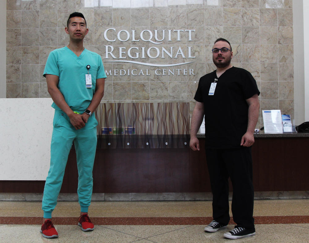 Psychiatry residents Xiun Ouyang and Anthony Cimino pose at Colquitt Regional Medical Center in Moultrie, Ga., on June 25, 2022. They are part of a new cohort training to become licensed psychiatrists after Colquitt Regional, which operates in a medically underserved area, got federal funding for the new program.