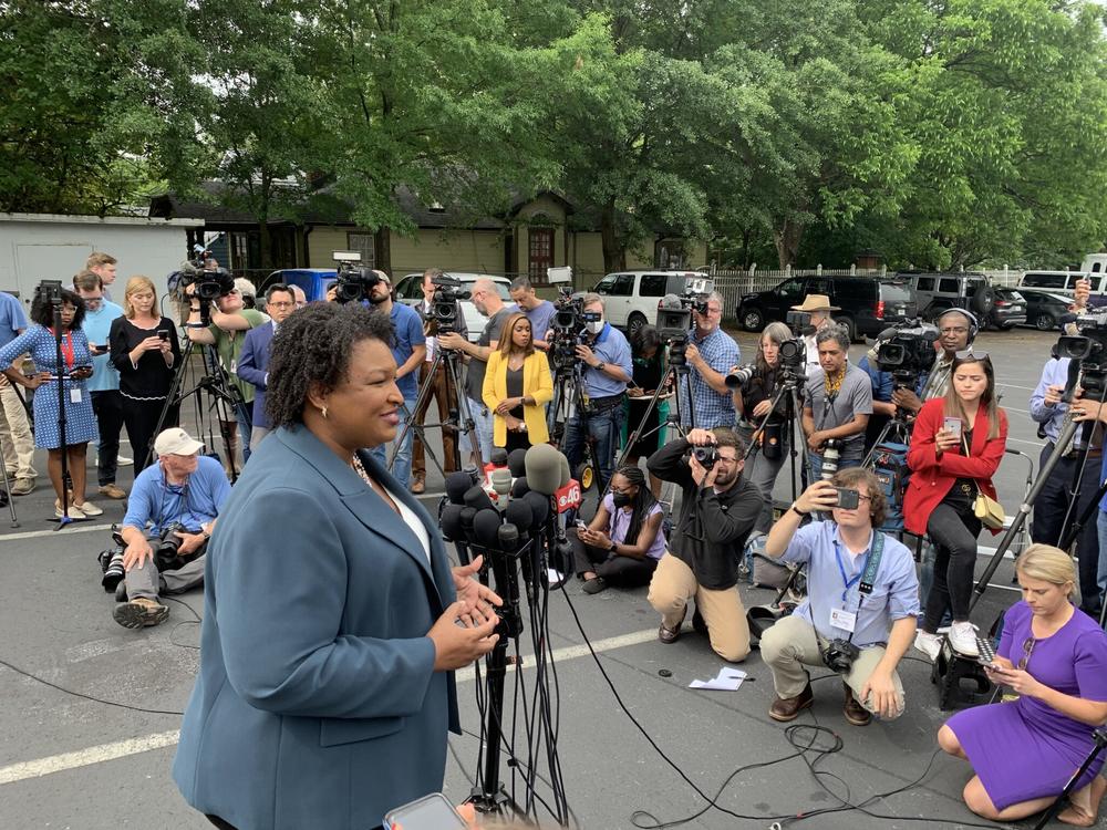 Abrams has put Medicaid expansion at the center of her 2022 campaign. Here she is seen talking to reporters in March. 