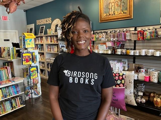 Erica Atkins is pictured in front of books at gifts at her bookstore in Locust Grove, Ga.