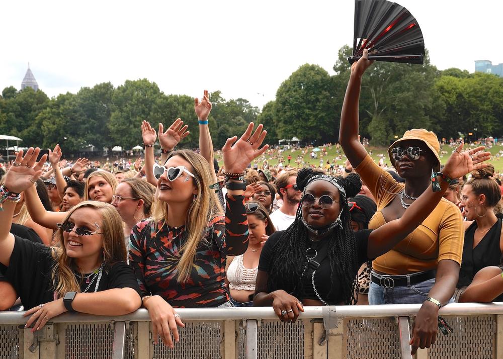 Festival attendees stand against barricades before the artist performs..