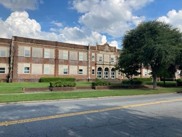 A 1925 school building is shown.