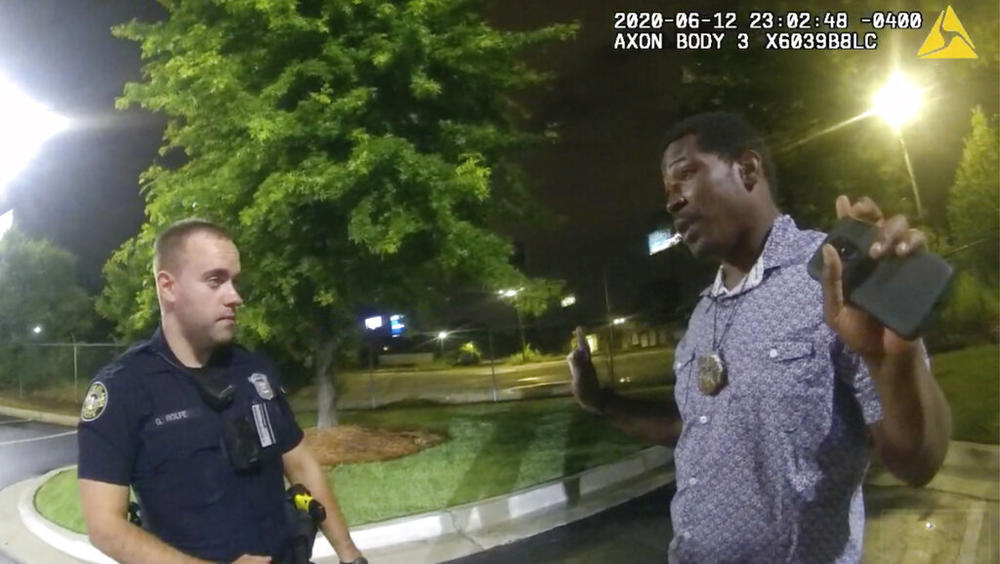 In this June 12, 2020, file photo from a screen grab taken from body camera video provided by the Atlanta Police Department, Rayshard Brooks, right, speaks with Officer Garrett Rolfe, left, in the parking lot of a Wendy's restaurant, in Atlanta. 