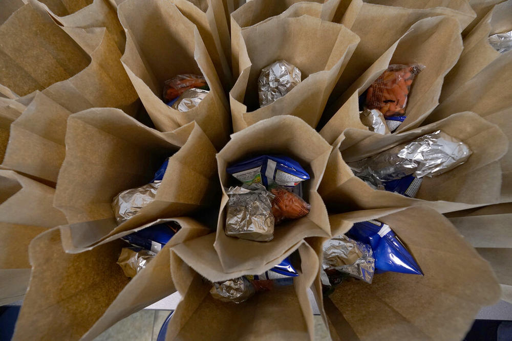 Bagged lunches await stapling before being distributed to students at Jefferson county's Tri-Plex Campus involving the students from the Jefferson County Elementary School, the Jefferson County Upper Elementary School and the Jefferson County Junior High School, March 3, 2021 in Fayette, Miss. 