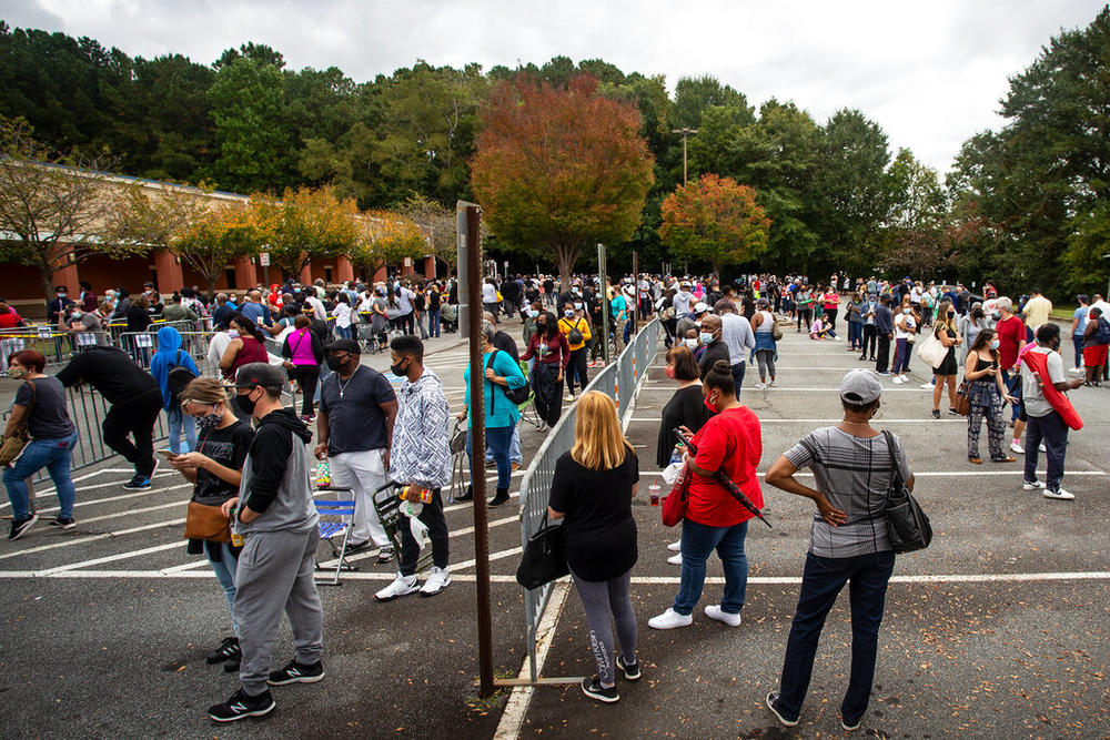  Hundreds of people wait in line for early voting on Oct. 12, 2020, in Marietta, Ga. State Election Board member Matt Mashburn testified at a hearing on Monday, July 18, 2022, that conduct he witnessed at this polling place led him to conclude it was necessary for the state to ban all gifts to waiting voters, including food and water.