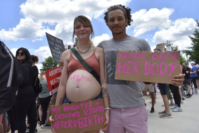 An expecting couple takes part in an abortion rights protest in Atlanta, May 14, 2022. 