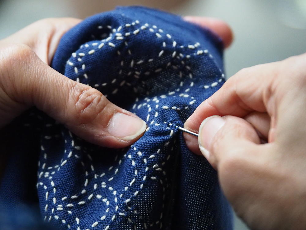 close up shot of hands sewing
