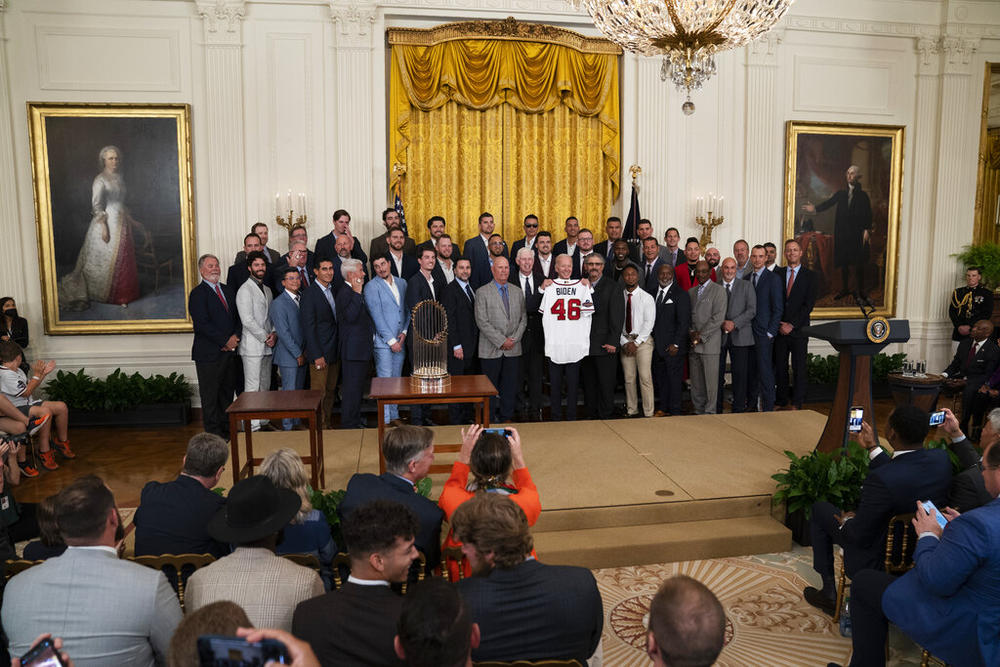 President Joe Biden poses for photographs during an event celebrating the 2021 World Series champion Atlanta Braves, in the East Room of the White House, Monday, Sept. 26, 2022, in Washington.