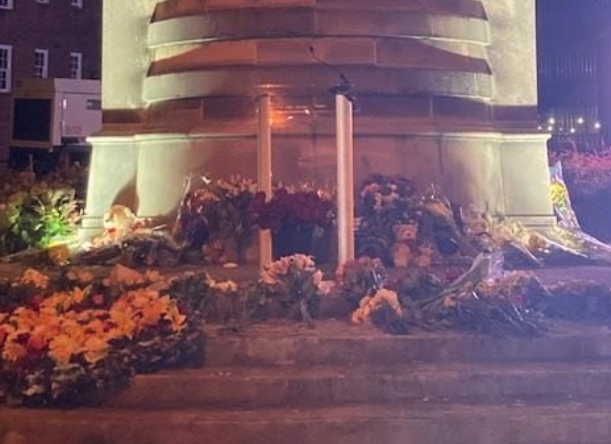 Mourners laid flowers at the base of The Prince of Wales's World Athletes Monument Monday morning during a live broadcast of Queen Elizabeth II's State Funeral. (Courtesy of Rodney Mims Cook Jr.)