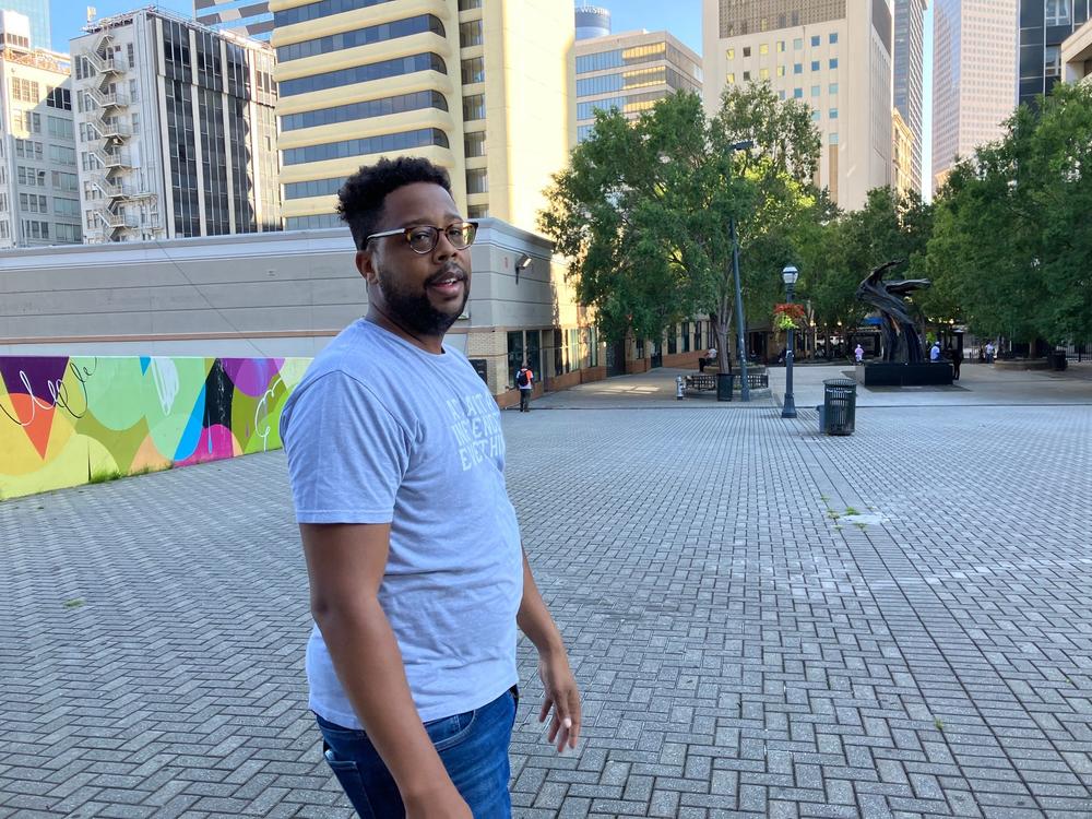 King Williams is shown standing at Five Points Plaza in downtown Atlanta.