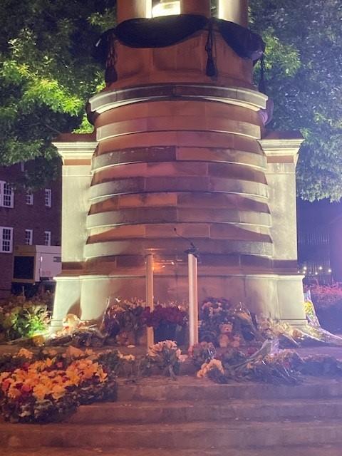 Mourners laid flowers at the base of The Prince of Wales's World Athletes Monument Monday morning during a live broadcast of Queen Elizabeth II's State Funeral.