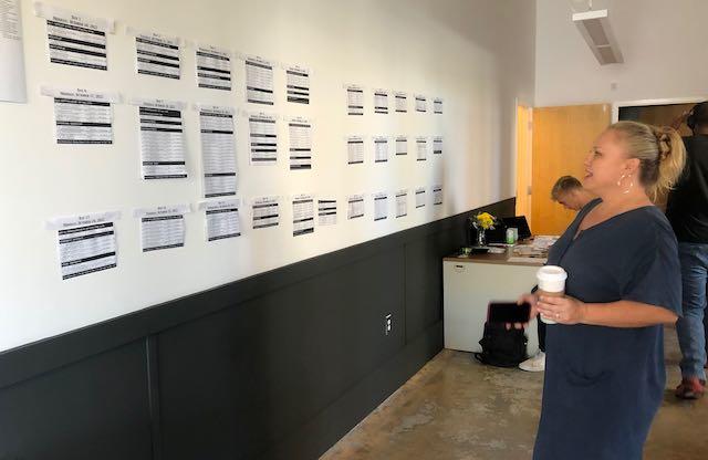 Rebekah Weigel of Peacetree Productions scans the shooting schedule Wednesday in their temporary Macon office at 338 Poplar St. (Liz Fabian)