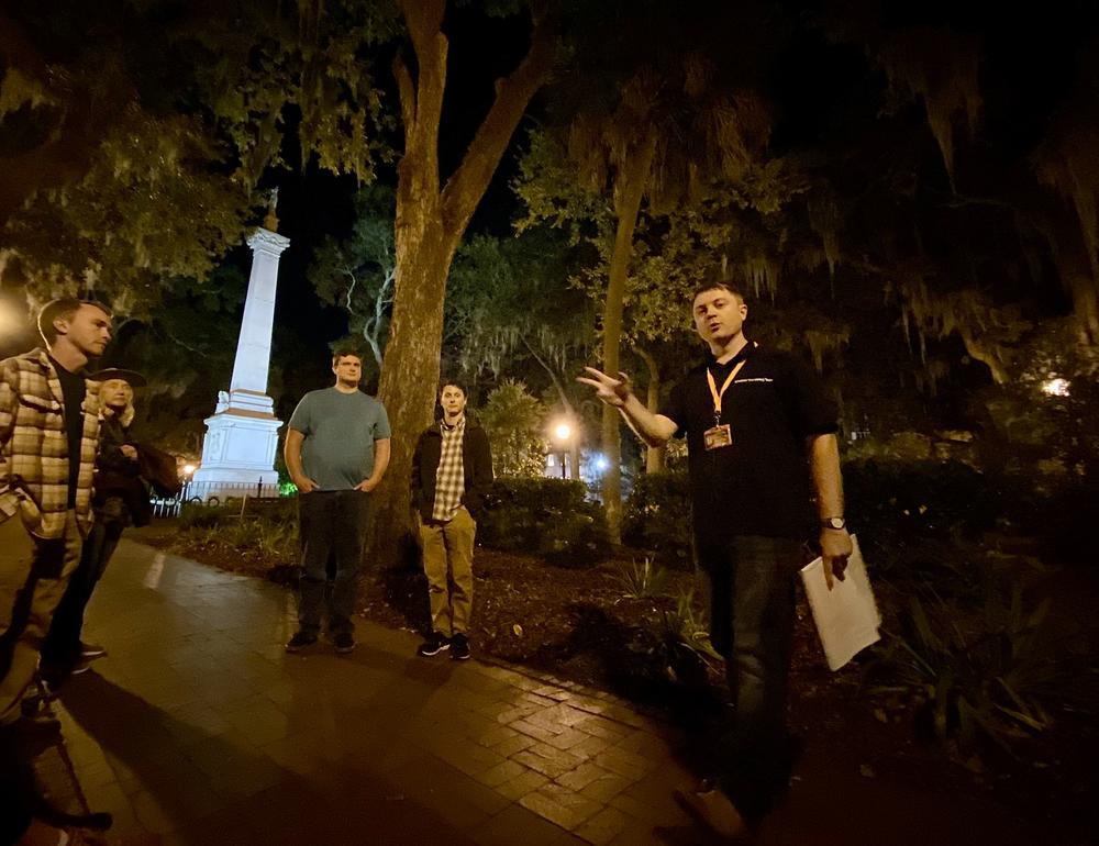 Brandon Carter leads his “Savannah Dark History Tour” in downtown's Monterey Square. The Casimir Pulaski Monument is in the background.