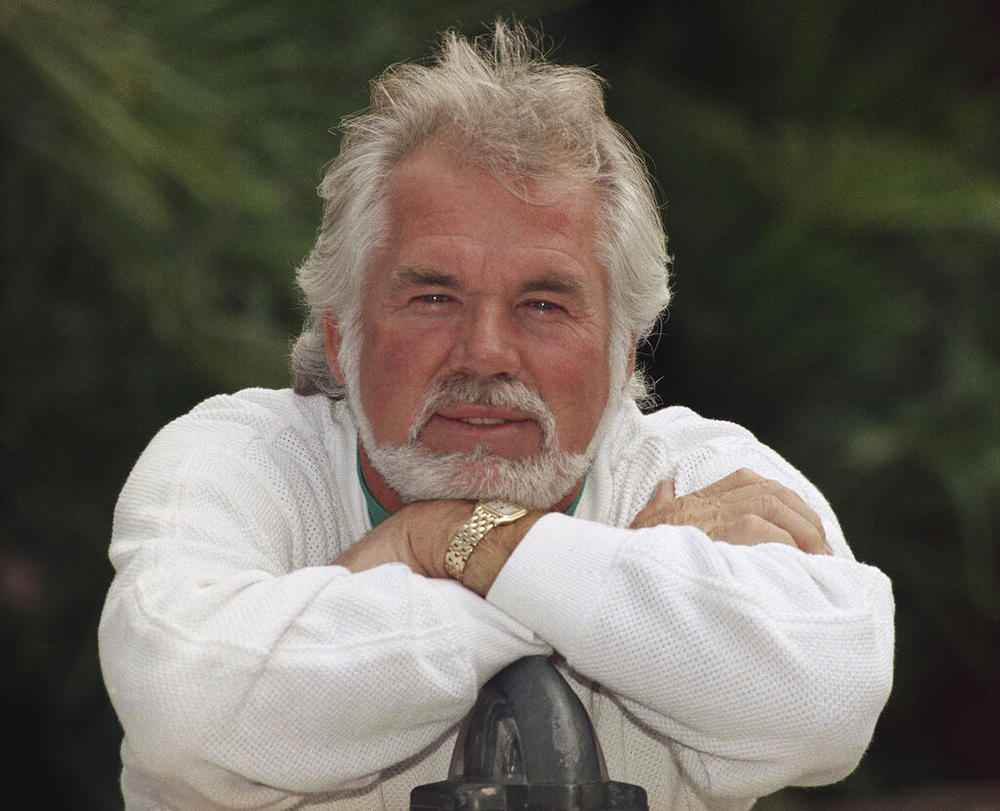 FILE - This May 17, 1989 file photo shows Kenny Rogers posing for a portrait in Los Angeles. Rogers, who embodied “The Gambler” persona and whose musical career spanned jazz, folk, country and pop, has died at 81. A representative says Rogers died at home in Georgia on Friday, March 20, 2020. (AP Photo/Bob Galbraith, File)
