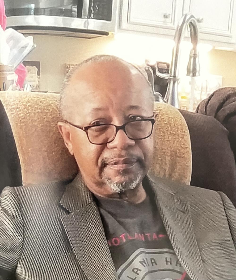 The Rev. Charles Sherrod is shown seated in his home.