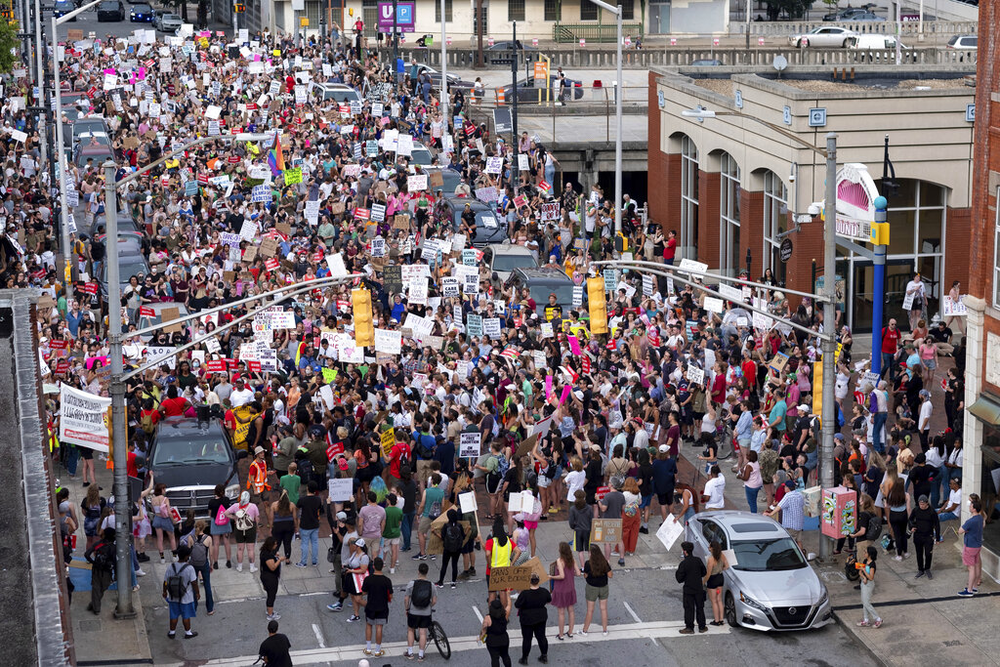 People gather in Downtown Atlanta on Friday, June 24, 2022, to protest to protest the Supreme Court's decision to overturn Roe v. Wade.