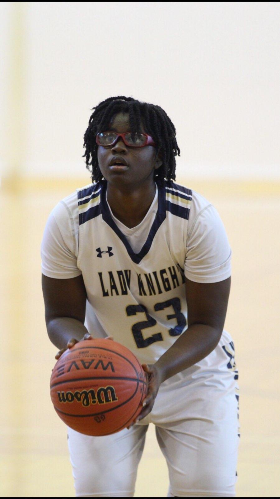 Basketball player Imani Bell, 16, is shown preparing to shoot a ball.